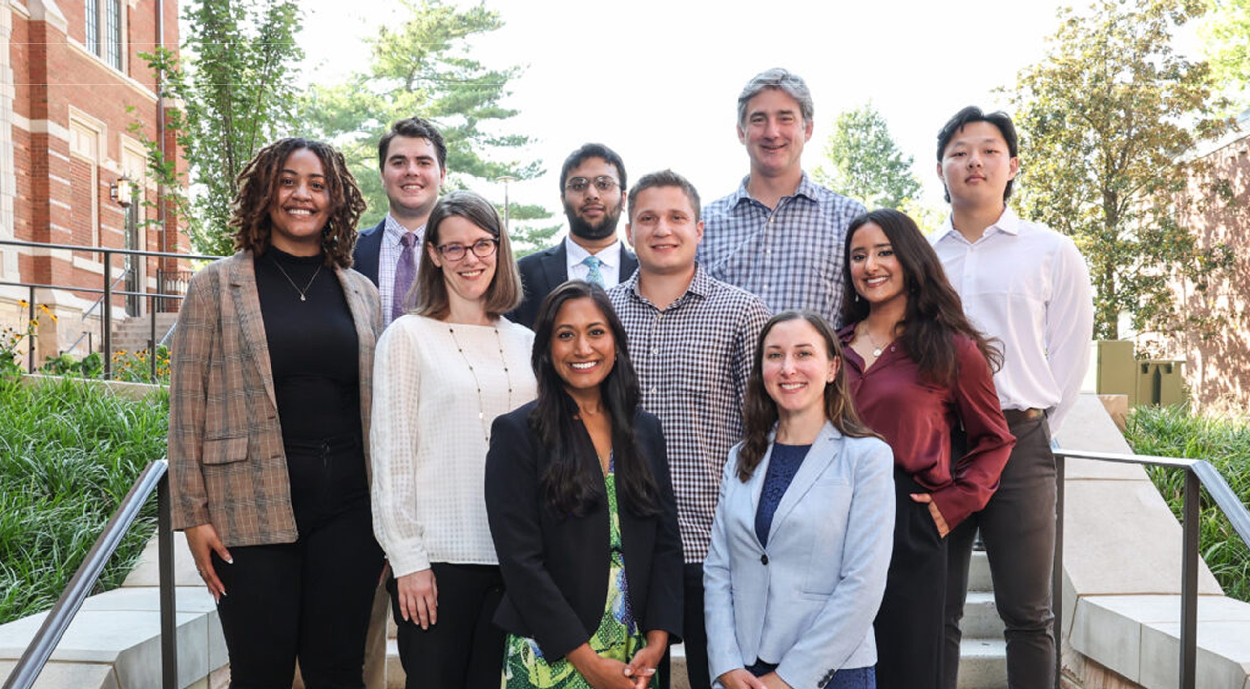 A group of smiling students and faculty poses for a photo at a VUSM MPH event.